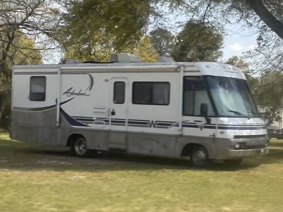Class A motorhome parked on grass