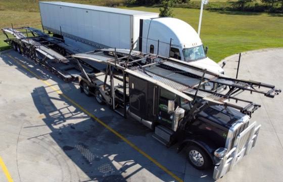 Car hauler trailer hitched to a semi truck